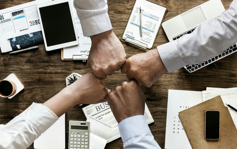 business people team members with fist to fist